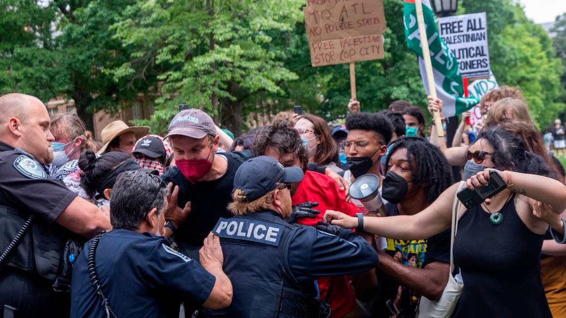 Pro-Palestinian demonstrators clash with police after replacing an American flag with a Palestinian flag Tuesday, April 30, 2024 at UNC-Chapel Hill. Police removed a “Gaza solidarity encampment” earlier Tuesday morning.