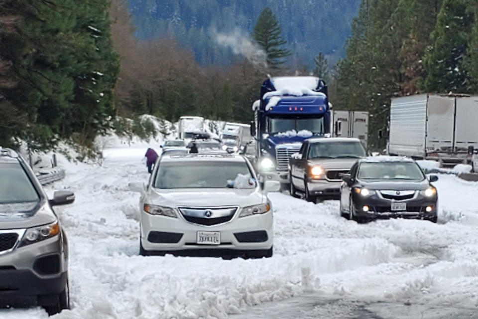 In this photo provided by Caltrans, are cars and trucks in stopped traffic on Interstate 5 near Dunsmuir, Calif., Wednesday, Nov. 27, 2019. Thanksgiving travel has been snarled in some places by two powerful storms. A winter storm blamed for one death and hundreds of canceled flights in the West moved into the Midwest on Wednesday and dropped close to a foot of snow in parts of Minnesota and Wisconsin. (Caltrans via AP)