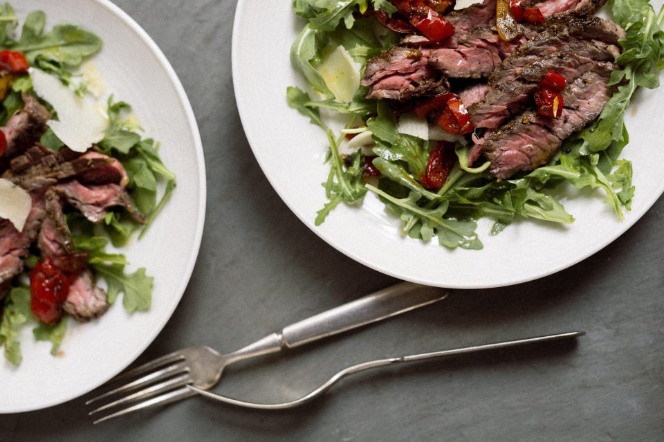 This image released by Milk Street shows a recipe for skirt steak salad with arugula and Peppadew peppers. (Milk Street via AP)