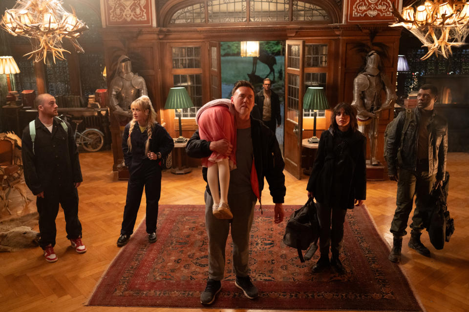 (from left) Dean (Angus Cloud), Sammy (Kathryn Newton), Abigail (Alisha Weir, back to camera), Peter (Kevin Durand), Frank (Dan Stevens, background), Joey (Melissa Barrera) and Rickles (Will Catlett) in Abigail, directed by Matt Bettinelli-Olpin & Tyler Gillett.