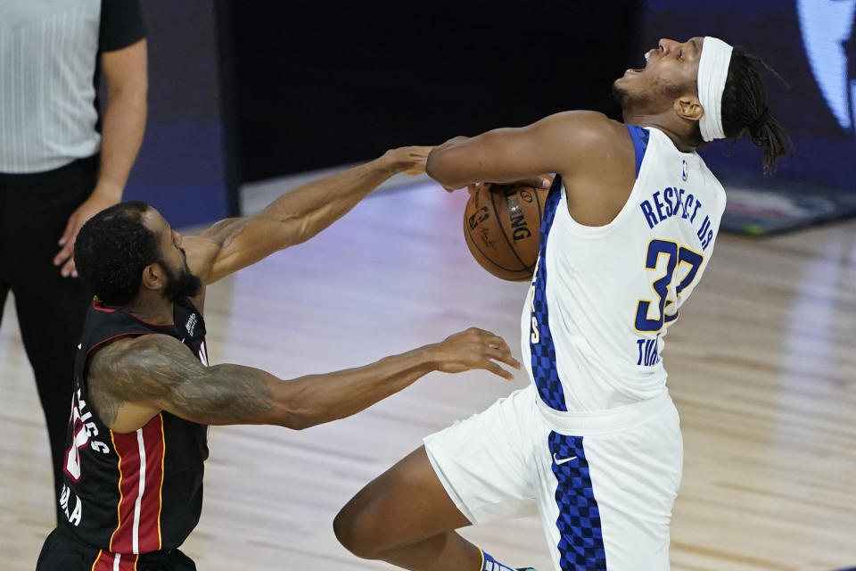 Miami Heat's Andre Iguodala, left, guards Indiana Pacers' Myles Turner (33) during the first half of an NBA basketball first round playoff game Monday, Aug. 24, 2020, in Lake Buena Vista, Fla. (AP Photo/Ashley Landis, Pool)