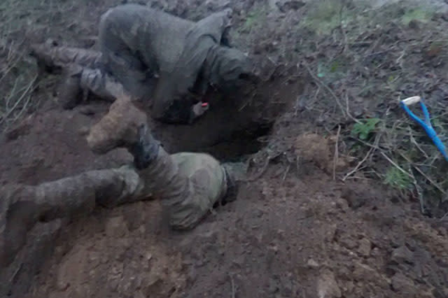 Terrier man digging out a badger sett