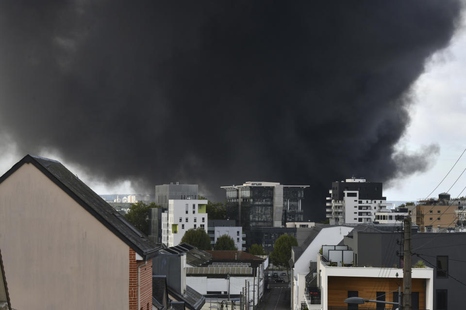 Black smoke is seen over Rouen, Normandy, after a fire broke at a chemical plant Thursday, Sept.26, 2019. An immense mass of black smoke is rising over Normandy as firefighters battle a blaze at a chemical plant, and authorities closed schools in 11 surrounding towns and asked residents to stay indoors. (AP Photo/Stephanie Peron)