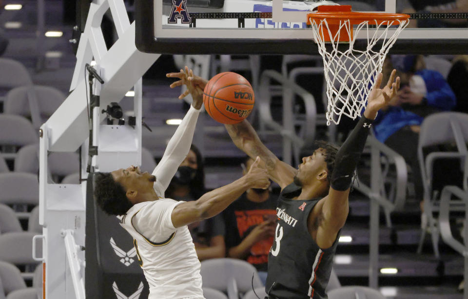 Wichita State guard Alterique Gilbert (3) and Cincinnati forward Tari Eason (13) collide under the basket during the first half of an NCAA college basketball game in the semifinal round of the American Athletic Conference men's tournament Saturday, March 13, 2021, in Fort Worth, Texas. (AP Photo/Ron Jenkins)