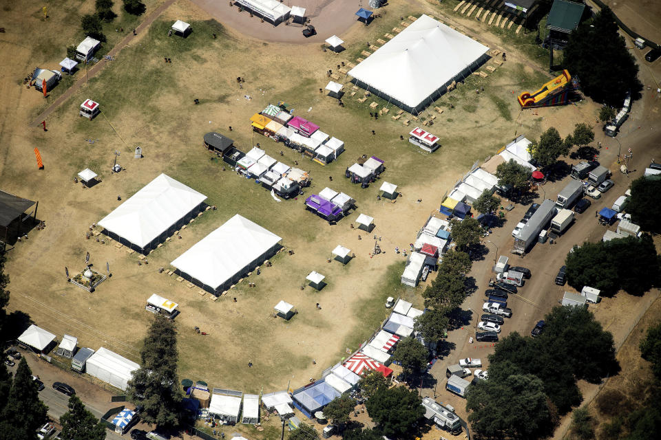 FILE - In this July 29, 2019 aerial file photo, vendor booths line Christmas Hill Park in Gilroy, Calif., the site of a shooting the day before, at the Gilroy Garlic Festival. A lawsuit announced Tuesday, Nov. 12, 2019, against the Gilroy Garlic Festival Association alleges that negligent security measures allowed a gunman to sneak in and fatally shoot three people. (AP Photo/Noah Berger, File)