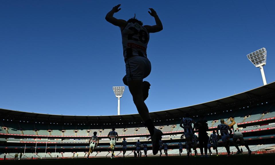 <span>Nathan Murphy runs out onto the MCG. The Collingwood defender has retired from AFL football on medical advice around concussions.</span><span>Photograph: Quinn Rooney/Getty Images</span>