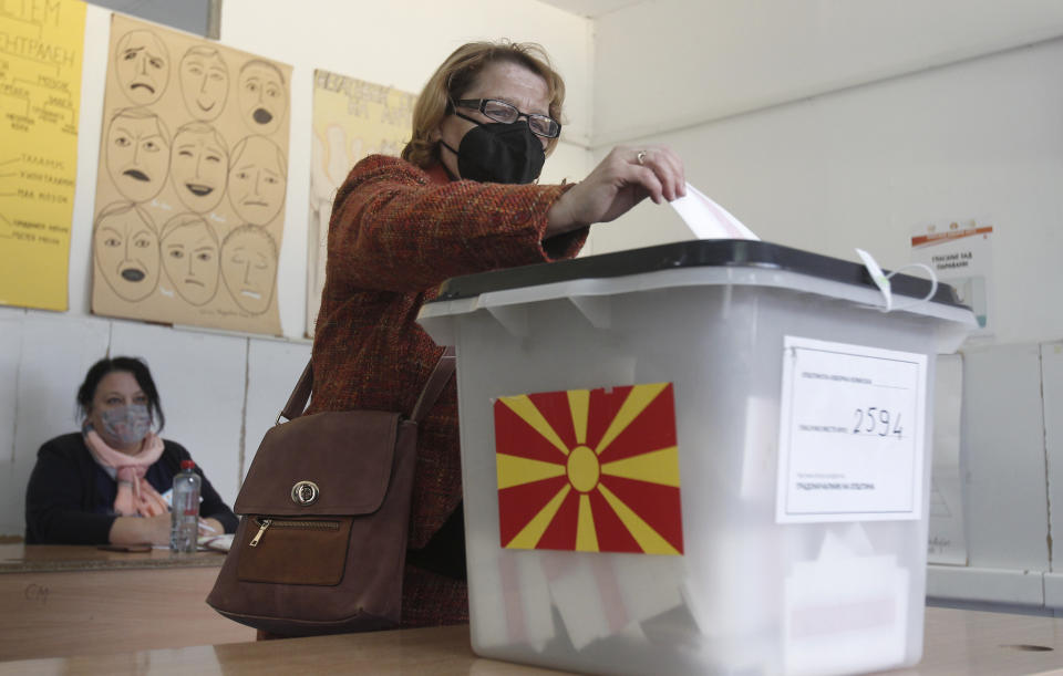 A woman casts her ballot at a polling station in Skopje, North Macedonia, on Sunday, Oct. 31, 2021. North Macedonia is holding a runoff of local elections on Sunday seen as key test for the leftist government after center-right opposition has won mayoral posts in 21 municipalities compared with only nine of ruling Social-democrats in the first round of the vote two weeks ago. (AP Photo/Boris Grdanoski)