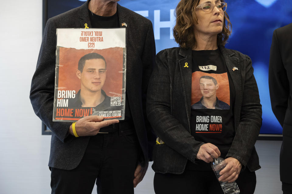 Ronen and Orna Neutra, parents of American hostage Omer Neutra, hold signs of their son during a press conference by families of American hostages in Gaza and elected officials, Friday, April. 5, 2024, in New York. (AP Photo/Yuki Iwamura)