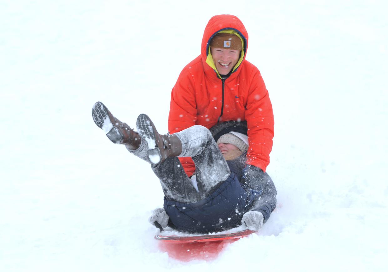 Zachary McVey and his girlfriend Billie Thomas, both of Springfield, sled down a hill at Pasfield Golf Course Wednesday, Feb. 2, 2022. [Thomas J. Turney/The State Journal Register]