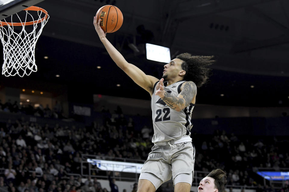 Providence's Devin Carter (22) lays up the ball to score during the first half of an NCAA college basketball game against Butler, Wednesday, Jan. 25, 2023, in Providence, R.I. (AP Photo/Mark Stockwell)