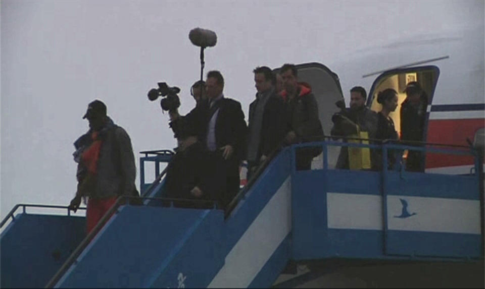 Retired U.S. basketball star Dennis Rodman disembarks from a plane upon arriving in North Korea