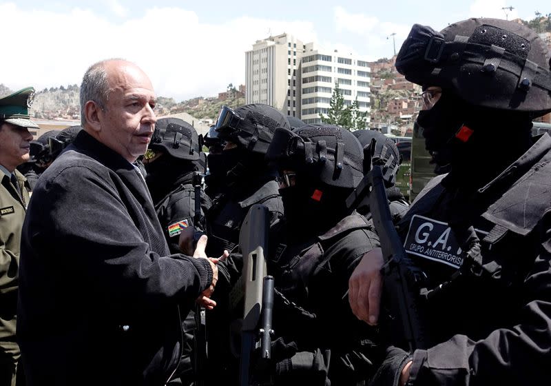 Government Minister Arturo Murillo shakes hands with members of Bolivian police antiterrorist group in La Paz