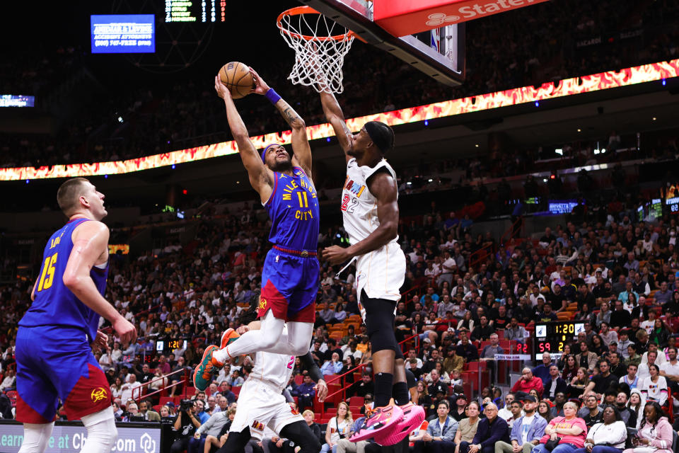 Denver Nuggets' No. 11 Bruce Brown dunks Miami Heat's No. 22 Jimmy Butler during the second quarter of a game at Miami-Dade Arena in Miami, Florida on February 13, 2023. rice field. Note to Users: By downloading or using this photo, you expressly acknowledge and agree that you agree to the terms of the Getty Images License Agreement.  (Photo credit: Megan Briggs/Getty Images)