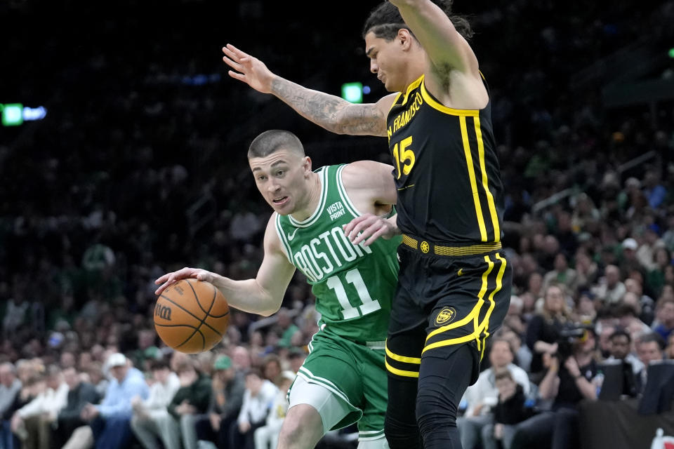 Boston Celtics guard Payton Pritchard (11) drives past Golden State Warriors forward Gui Santos (15) in the second half of an NBA basketball game, Sunday, March. 3, 2024, in Boston. (AP Photo/Steven Senne)