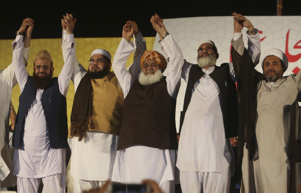 In this July 15, 2018, file photo in Karachi, Pakistan, Maulana Fazlur Rehman, center, a pro-Taliban, anti-U.S. radical Islamic leader, heads the Muttahida Majlis-e-Amal, an election alliance of radical religious groups which ruled Pakistan's northwest from 2002 to 2007 after the 2002 parliamentary elections following the Sept. 11, 2001 attacks in the United States. Pakistan's parliamentary elections on July 25 will mark the second time a democratically elected government in this Islamic nation has been succeeded by another. (AP Photo/Fareed Khan, File)