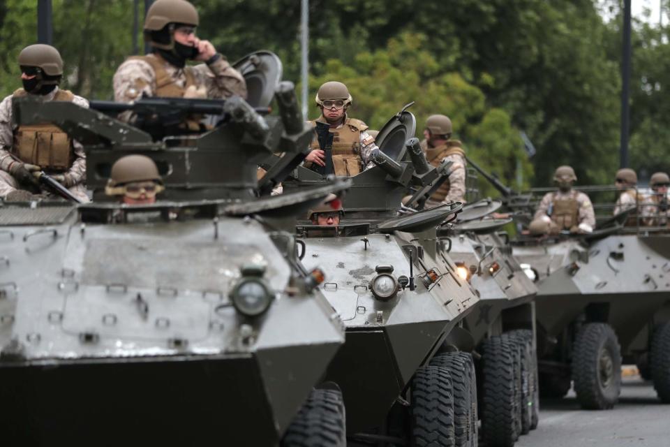 Soldiers patrol the streets of Santiago after a state of emergency was declared (REUTERS)