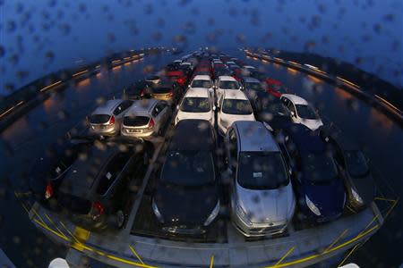 Newly manufactured Ford Fiesta cars are seen on the deck of the car transport ship "Tossa", during its journey from a Ford plant in the German city of Cologne to the Dutch seaport of Vlissingen, as it enters a water-gate at Krammer in the Netherlands September 13, 2013. REUTERS/Wolfgang Rattay