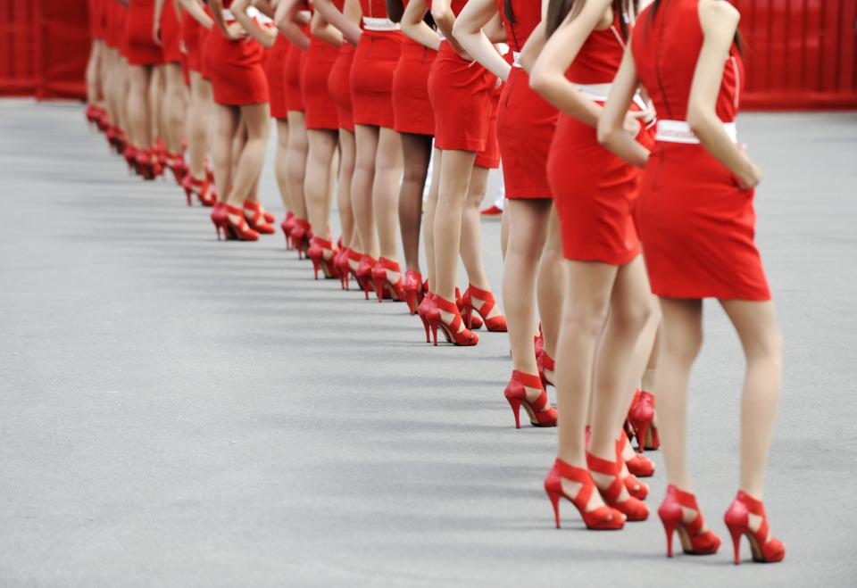 Red faced? Grid girls line up before the 2012 Spanish Grand Prix