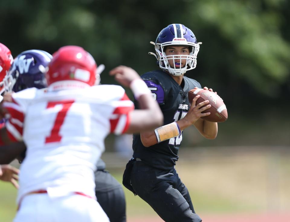 Monroe-Woodbury quarterback David Fennessy (15) looks upfield for an open receiver during their 36-14 win over North Rockland at North Rockland High School in Thiells on Saturday, September 3, 2022.