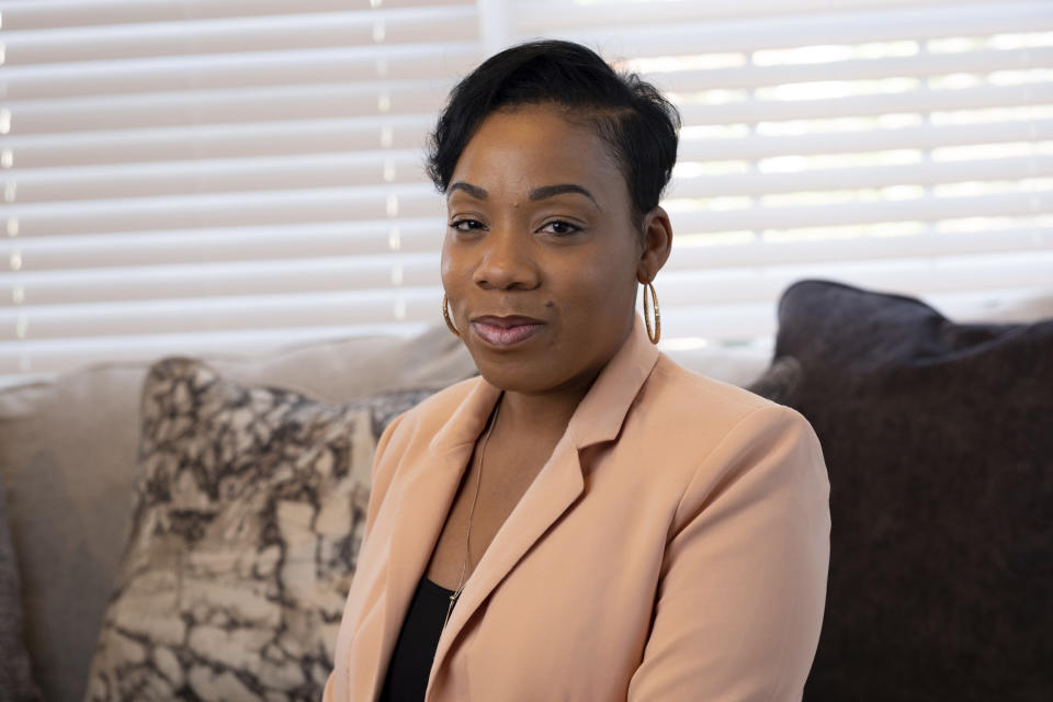 April Chapman, a small business owner, poses for a photo Tuesday, Dec. 27, 2022, at her home in Conyers, Ga. Chapman who lives in metro Atlanta switched from Democrat to Republican after the 2012 election. (AP Photo/Ben Gray)