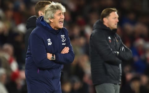 West Ham United's Chilean manager Manuel Pellegrini (L) gestures on the touchline during the English Premier League football match between Southampton and West Ham United at St Mary's Stadium in Southampton, - Credit: AFP