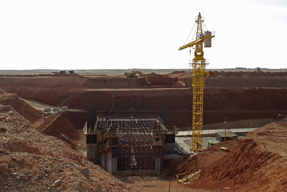 FILE - A crane hovers above the site of a new shaft under construction at the Oyu Tolgoi mine site in Khanbogd village, Umnugobi province, Mongolia, Nov. 7, 2009. The Oyu Tolgoi mine in the Gobi Desert in the country's south is one of the world's largest known copper and gold deposits. (AP Photo/Ganbat Namjilsangarav, File)