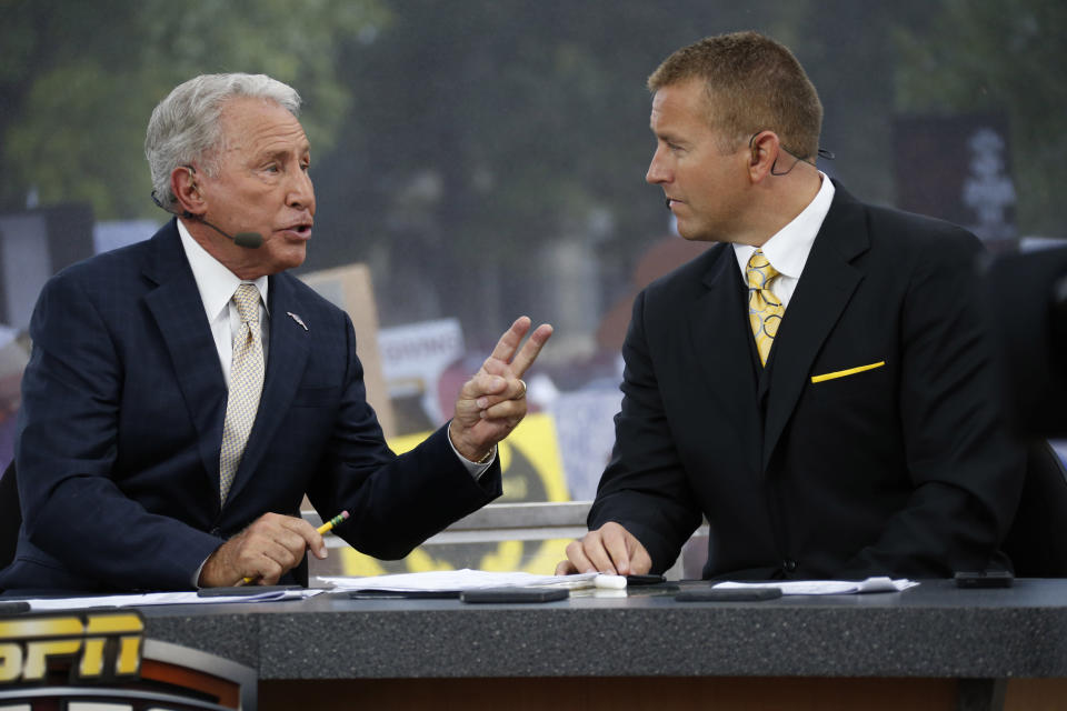 ESPN College GameDay hosts Lee Corso, left, and Kirk Herbstreit confer during the telecast from The Junction prior to Mississippi State playing Auburn in an NCAA college football game in Starkville, Miss., Saturday, Oct 11, 2014. No.3 Mississippi State beat No. 2 Auburn 38-23. (AP Photo/Rogelio V. Solis)