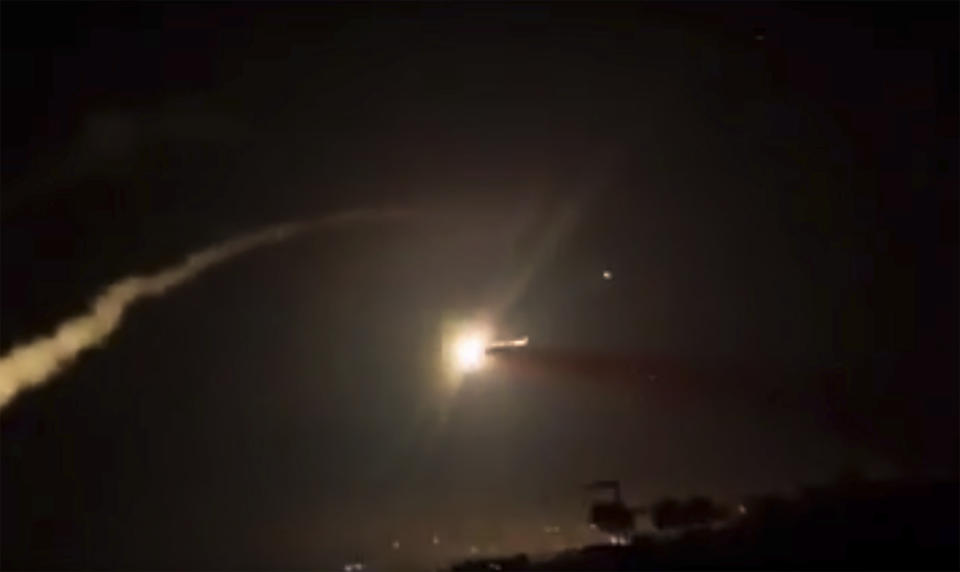 This frame grab from a video provided by the Syrian official news agency SANA shows missiles flying into the sky near Damascus, Syria, Tuesday, Dec. 25, 2018. Israeli warplanes flying over Lebanon fired missiles toward areas near the Syrian capital of Damascus late Tuesday, hitting an arms depot and wounding three soldiers, Syrian state media reported, saying that most of the missiles were shot down by air defense units. (SANA via AP)