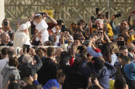 Pope Francis blesses a child wearing a pontiff costume as he tours St. Peter's Square on the popemobile during the weekly general audience at the Vatican, Wednesday, Nov. 15, 2023. (AP Photo/Gregorio Borgia)