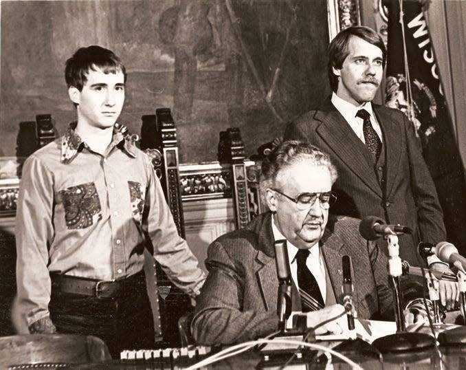 In 1982 Gov. Lee Dreyfus signs into law the Gay Rights Bill. Standing to the left is activist Leon Rouse. Standing to the right is State Representative David Clarenbach.