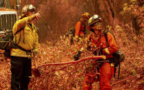 Inmate firefighters clear brush while battling the Fawn Fire burning north of Redding in Shasta County, Calif., on Thursday, Sep. 23, 2021. (AP Photo/Ethan Swope)