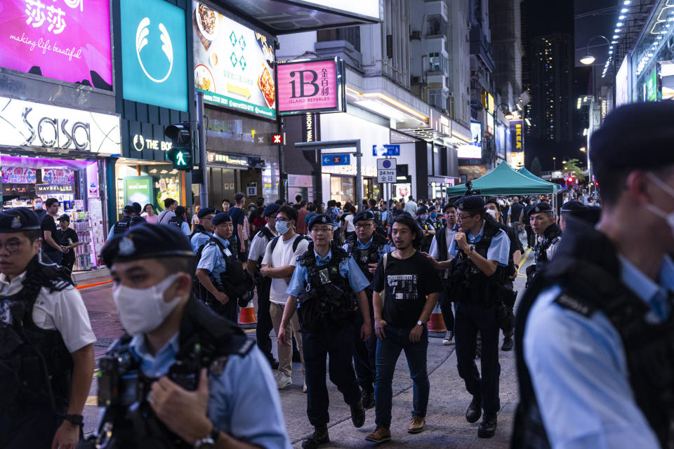 Activist Leo Tang is taken away by police near Victoria Park, the city's venue for the annual 1989 Tiananmen massacre vigil, on the 34th anniversary of China's Tiananmen Square crackdown in Hong Kong, Sunday, June 4 2023. (AP Photo/Louise Delmotte)