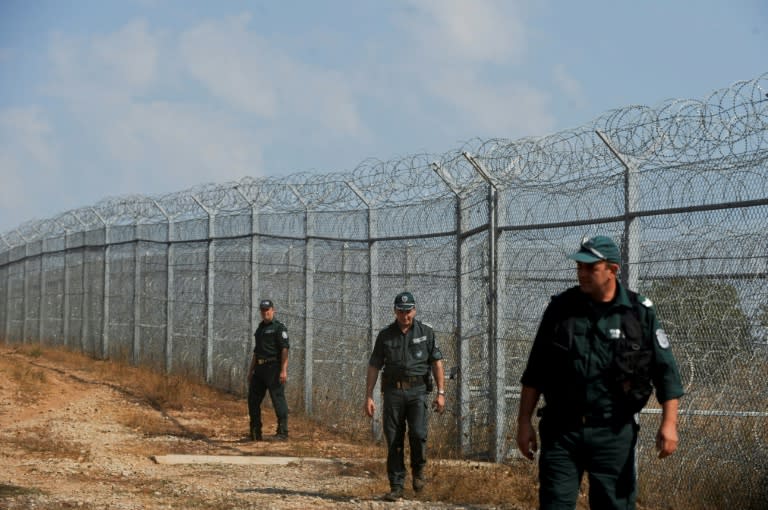 Bulgarian border police patrol next to a barbed wire fence on the border with Turkey