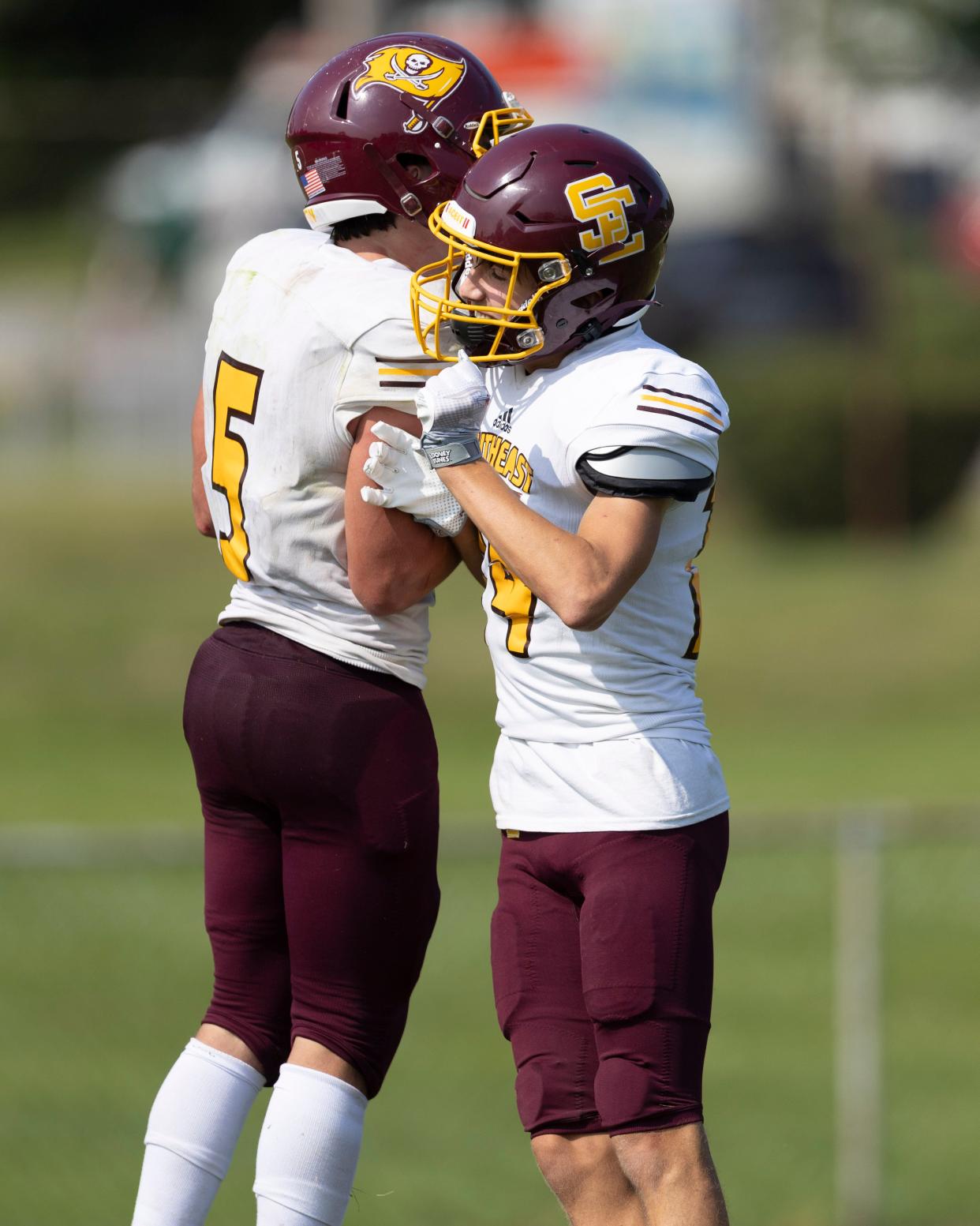 Southeast's Bryer Pickana, left, and Austin Mejia celebrate after a Pickana touchdown against Akron Garfield in Week 1.