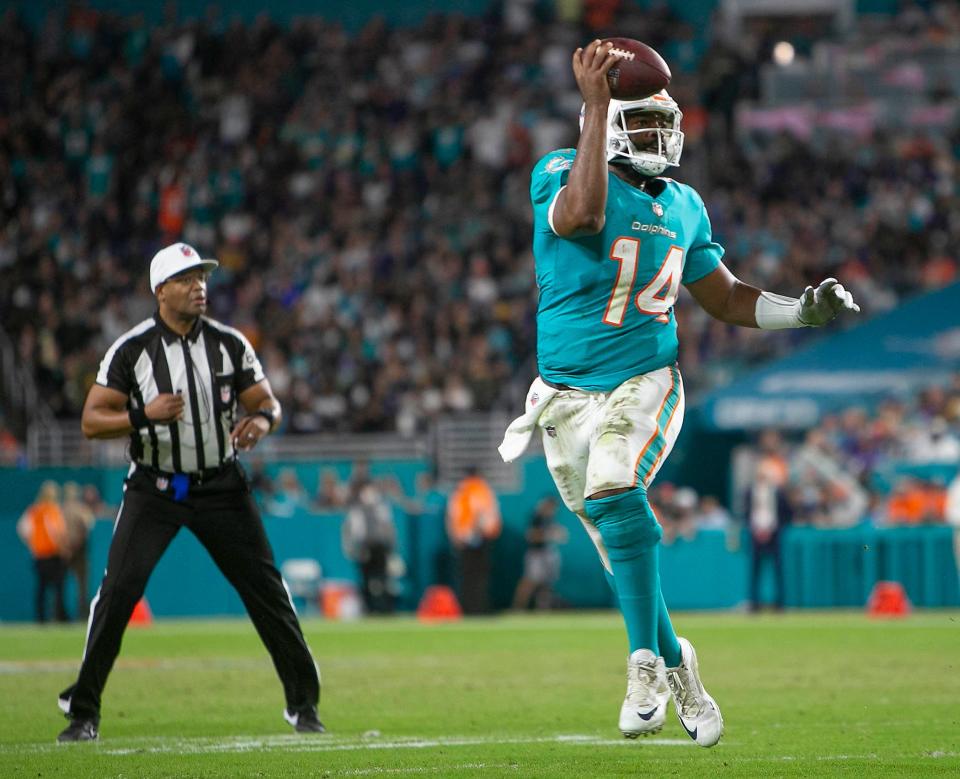 Miami Dolphins quarterback Jacoby Brissett (14), runs against the Baltimore Ravens during NFL game at Hard Rock Stadium Thursday in Miami Gardens. 