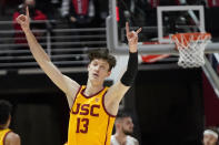 Southern California guard Drew Peterson (13) celebrates after scoring a three-point basket against Utah in the second half during an NCAA college basketball game Saturday, Jan. 22, 2022, in Salt Lake City. (AP Photo/Rick Bowmer)