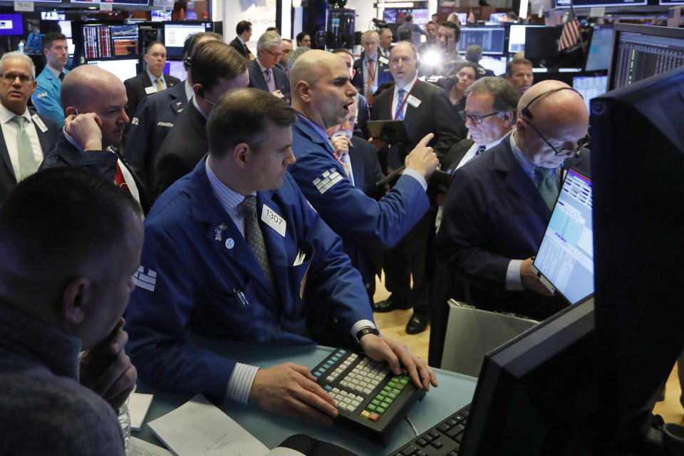 Specialist Philip Finale, background center, works with traders on the floor of the New York Stock Exchange, Monday, March 9, 2020. The Dow Jones Industrial Average plummeted 1,500 points, or 6%, following similar drops in Europe after a fight among major crude-producing countries jolted investors already on edge about the widening fallout from the outbreak of the new coronavirus. (AP Photo/Richard Drew)