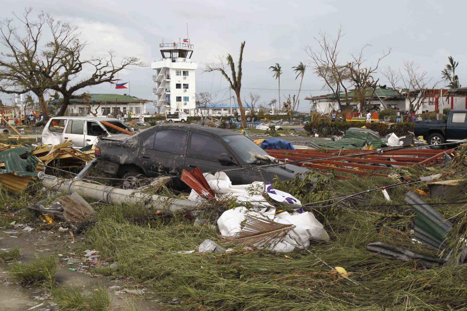 Vehicles washed away by floodwaters are seen at a rice field after super Typhoon Haiyan battered Tacloban city