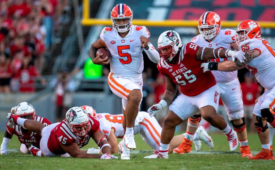 Clemson quarterback D.J. Uiagalelei breaks away from N.C. State’s Davin Vann (45) and Joshua Harris (55) for a 37-yard gain in the fourth quarter on Saturday September 25, 2021 at Carter-Finley Stadium in Raleigh, N.C.