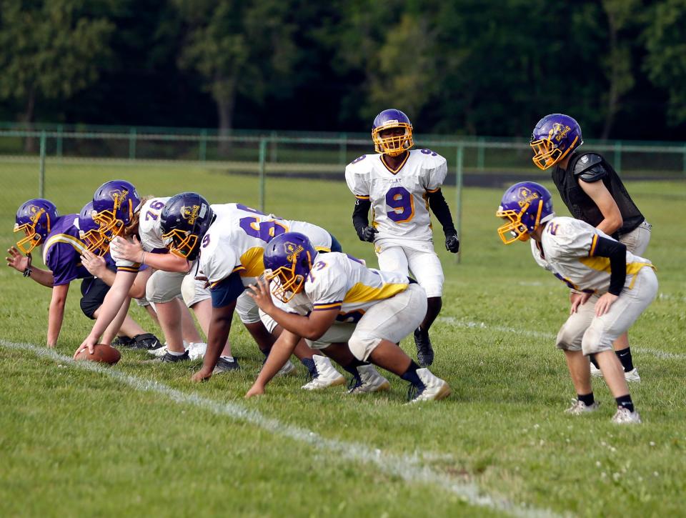 Players on the South Bend Clay football team take reps on offense during practice Monday, August 7, 2023, at Clay High School in South Bend.