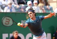 Roger Federer of Switzerland returns the ball to Novak Djokovic of Serbia, during their semifinal match of the Monte Carlo Tennis Masters tournament in Monaco, Saturday, April, 19, 2014. Federer won 7-6, 6-2. (AP Photo/Claude Paris)