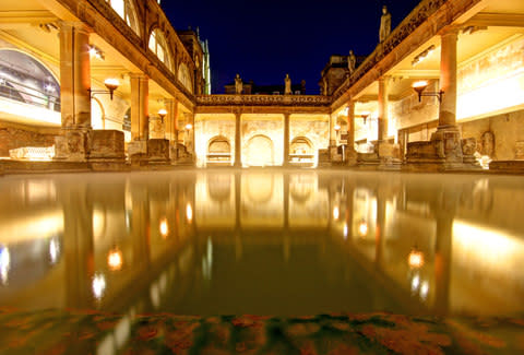 After dusk, the Great Bath is lit by torches and very atmospheric - Credit: AP