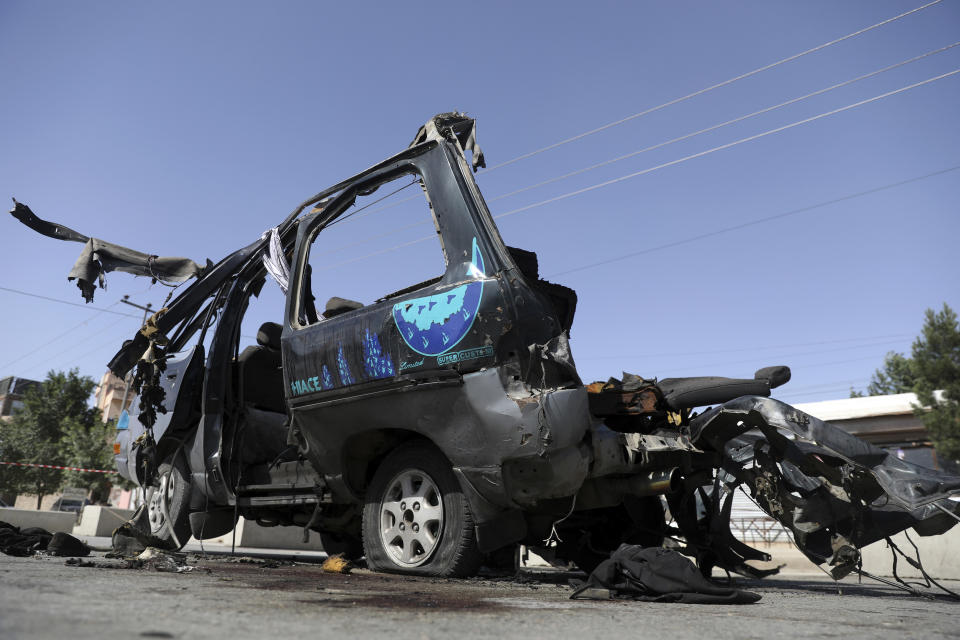 A minivan is seen after a bomb explosion in Kabul, Afghanistan, Thursday, June 3, 2021. Police say a bomb has ripped through a minivan in the western part of the Afghan capital Kabul, killing at least four people. No one took responsibility for the attack in the neighborhood, which is largely populated by the minority Hazara ethnic group who are mostly Shiite Muslims. (AP Photo/Rahmat Gul)