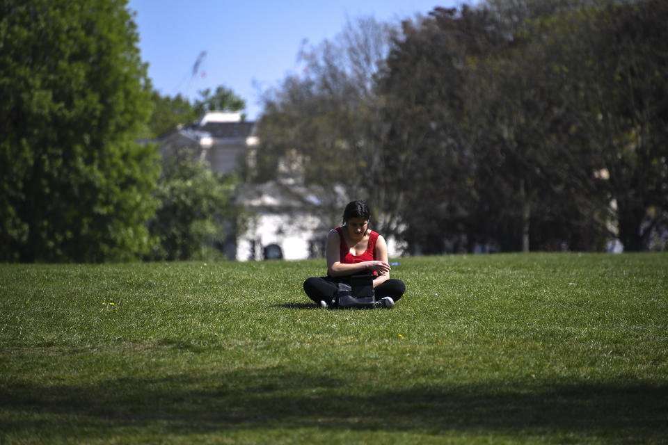 People enjoy the sunny weather at Regent's Park, as the lockdown continues due to the coronavirus outbreak, in London, Sunday, April 26, 2020. The public have been asked to self isolate, keeping distant from others to limit the spread of the contagious COVID-19 coronavirus. (AP Photo/Alberto Pezzali)