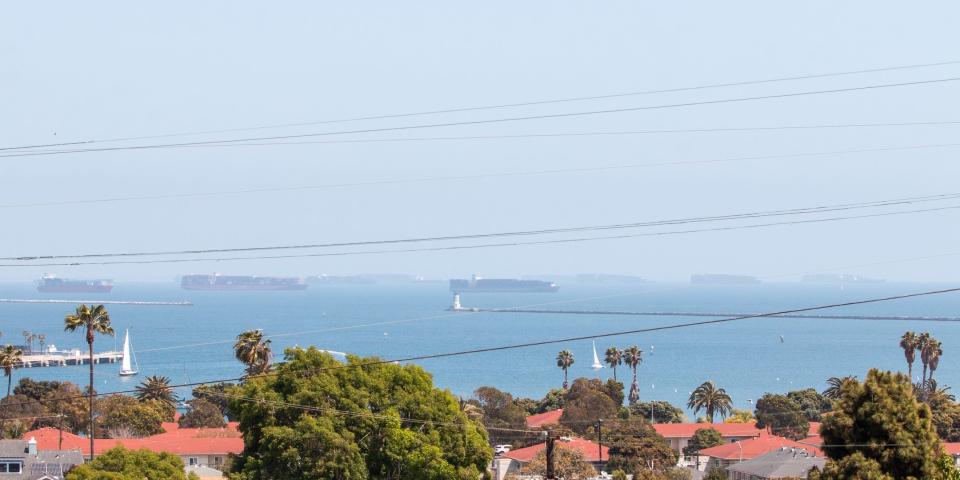 Container ships waiting at the port of Long Beach, California.