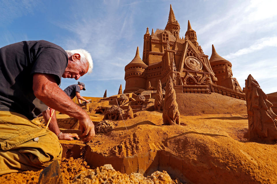 <p>Sand carver Franco Daga from Italy works on a sculpture during the Sand Sculpture Festival “Disney Sand Magic” in Ostend, Belgium June 22, 2017. (Yves Herman/Reuters) </p>