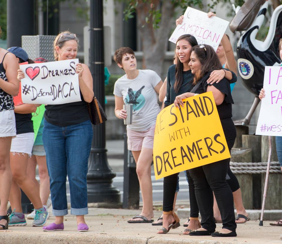 Grace Resendez McCaffery, right, and Jessica Rangel, 21, hug as they and other protestors in support of DACA gathered at the corner of Palafox and Garden Streets in Pensacola on Sept. 5, 2017. United States attorney general Jeff Sessions announced the end of the DACA program.