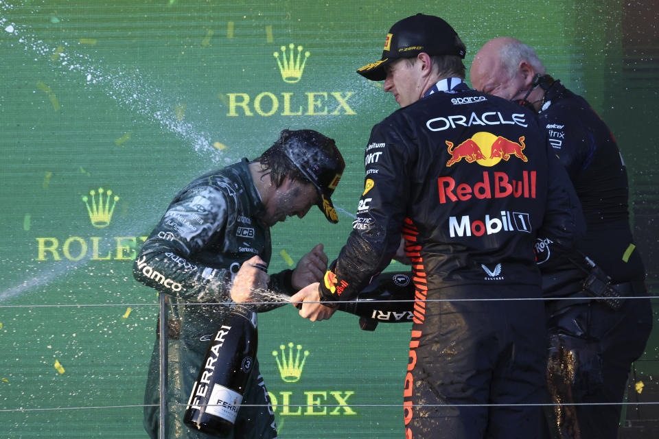 Red Bull driver Max Verstappen of Netherlands, center, Rob Marshall, Red Bull's chief of engineering and Aston Martin driver Fernando Alonso of Spain, left, are sprayed with champagne on the podium after the Australian Formula One Grand Prix at Albert Park in Melbourne, Sunday, April 2, 2023. Verstappen won the race. (AP Photo/Asanka Brendon Ratnayake)