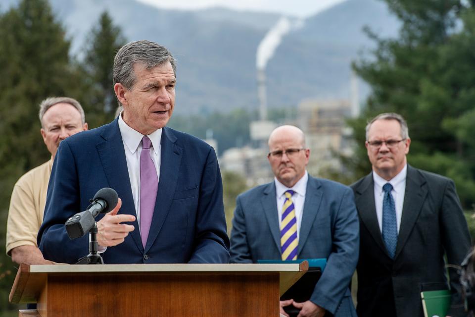 Gov. Roy Cooper speaks in Canton with the mill in the background April 6, 2023.