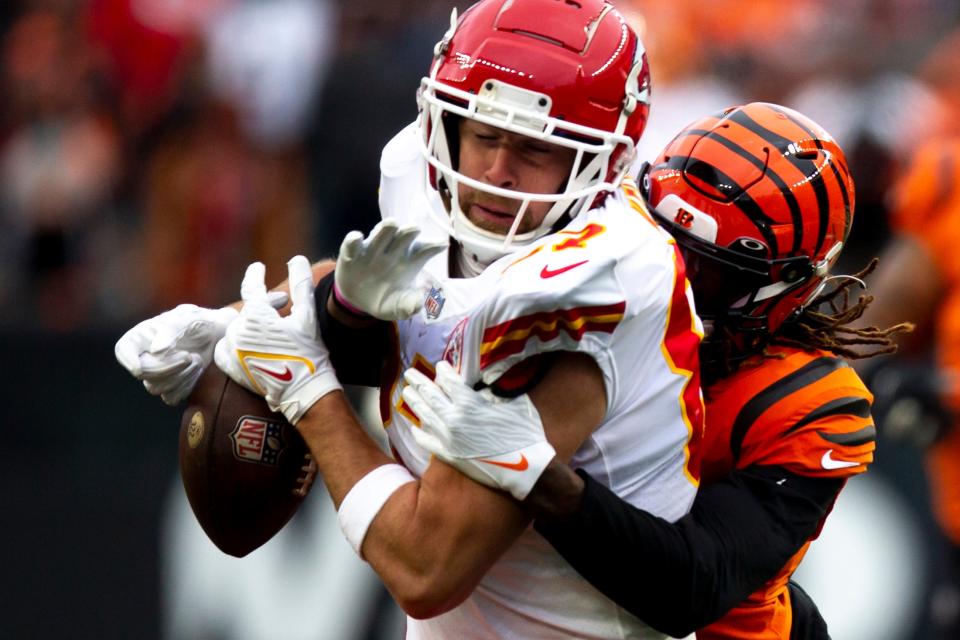 Kansas City Chiefs tight end Travis Kelce (87) drops a pass as he is hit by a bengals defender in the second half of the NFL game on Sunday, Jan. 2, 2022, at Paul Brown Stadium in Cincinnati. Cincinnati Bengals defeated Kansas City Chiefs 34-31. 